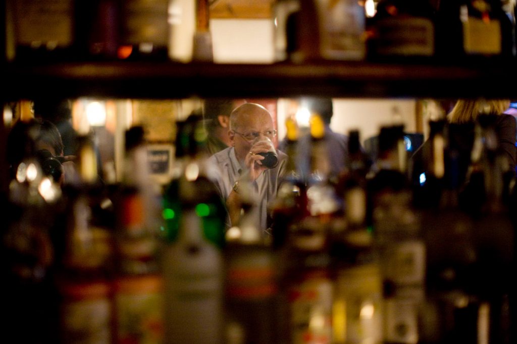 A man drinks at the bar of White Horse Tavern, a well-known bar in NYC. 