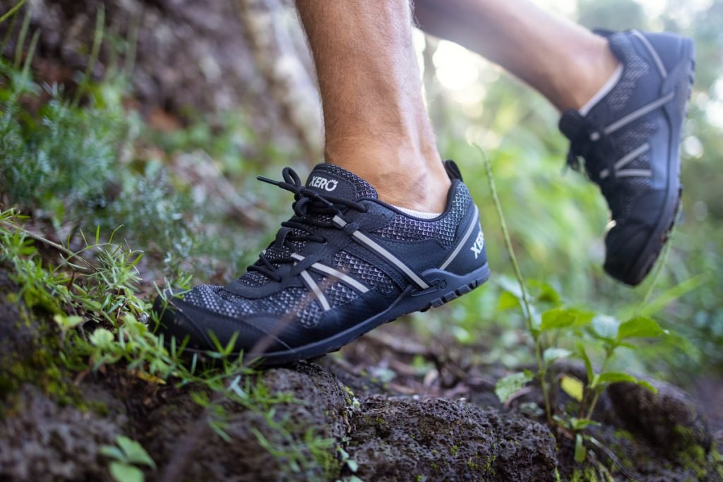A man hikes on a trail wearing the Xero Shoes TerraFlex. 