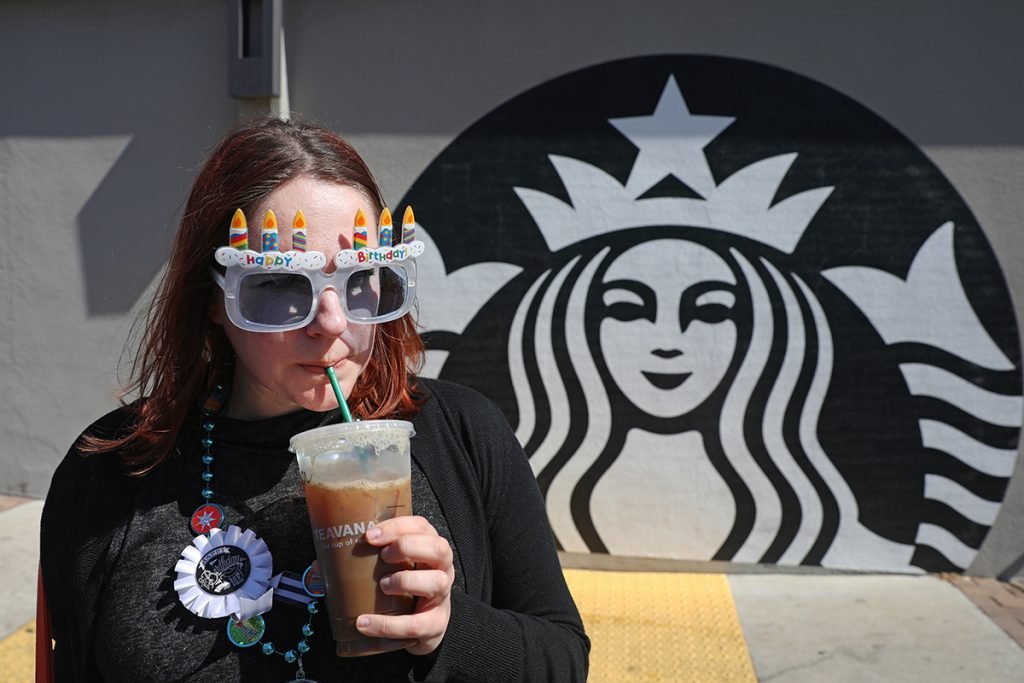 Robin Hartill, an editor at The FinanceGrabber, sips an iced coffee she got for free on her birthday at Starbucks in Saint Petersburg, Fla.
