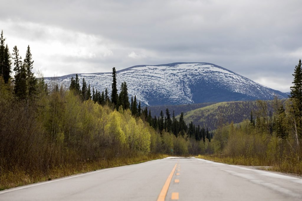 A road shows a view of mountains in Alaska.