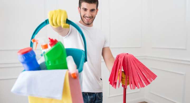 Man holding cleaning supploes