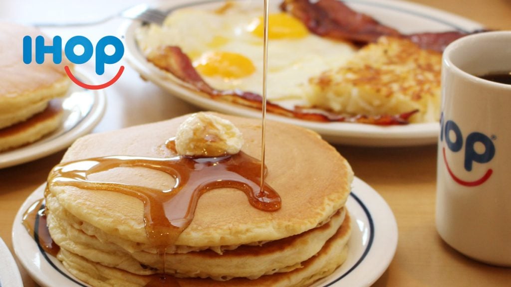 This is a photo of an American breakfast: pancakes, bacon, eggs and has browns from IHOP.